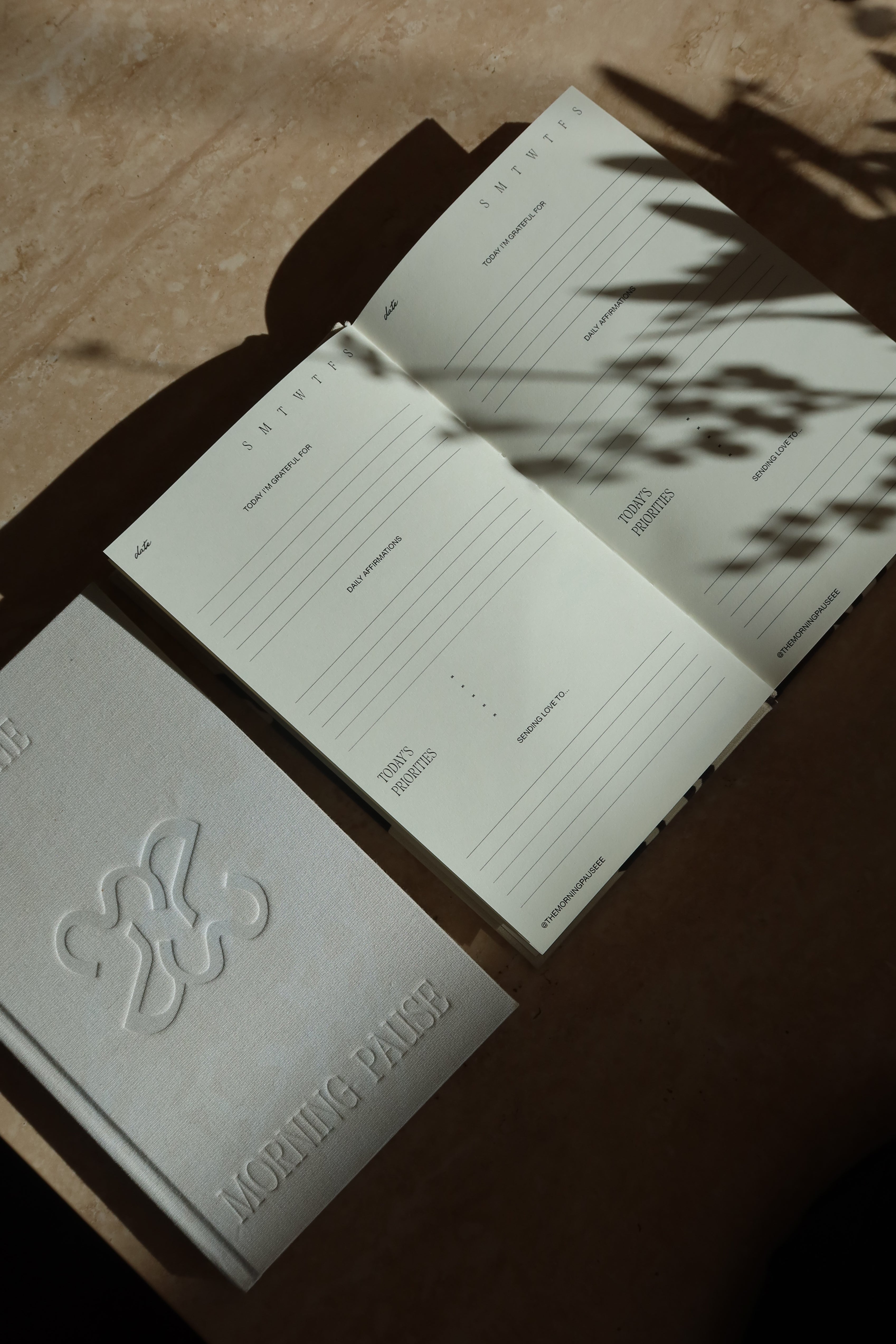 Open book with embossed design on a textured surface