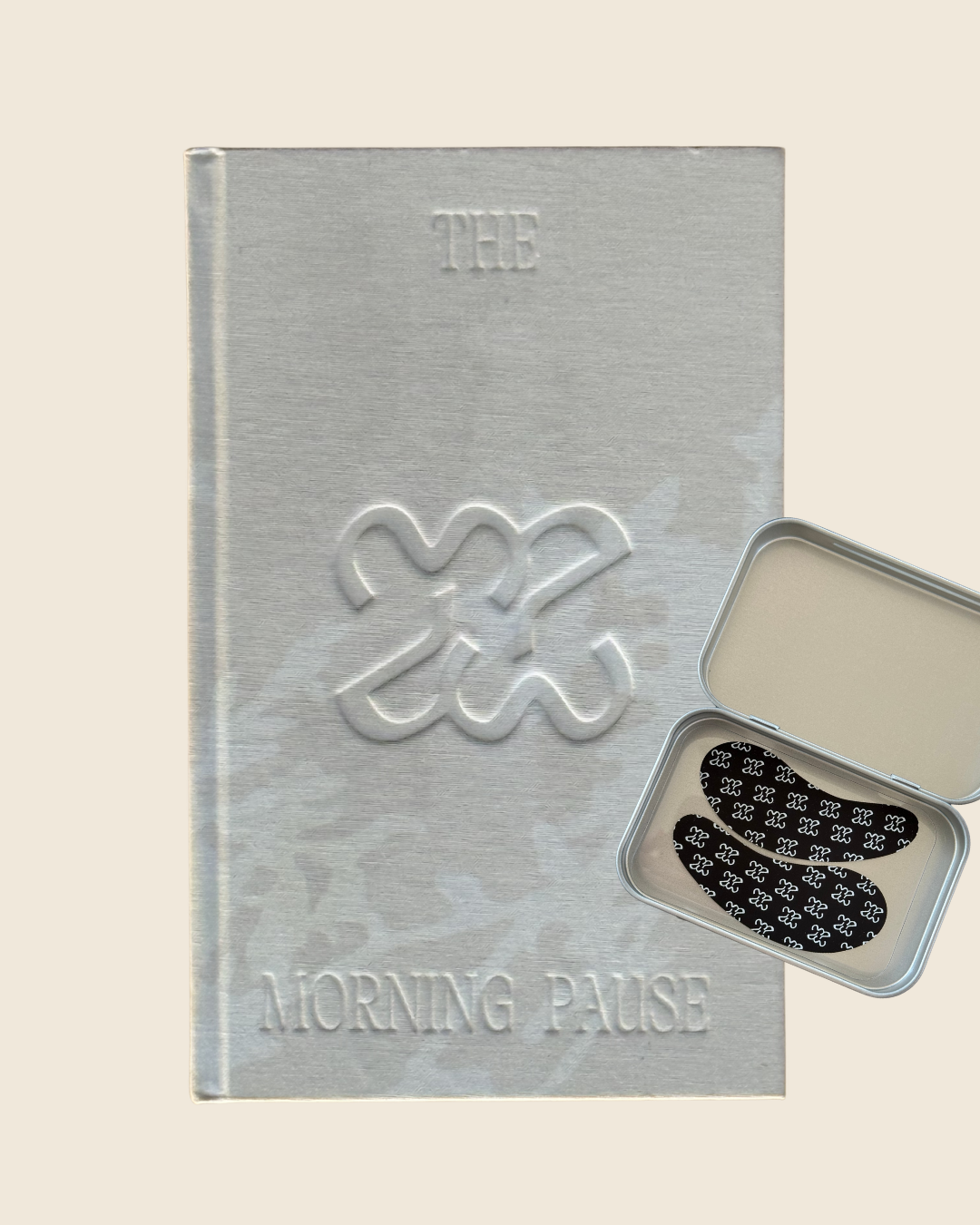 The Morning Pour bundle — Oat Milk journal with botanical silhouette shadow and open Morning Pause reusable eye mask tin