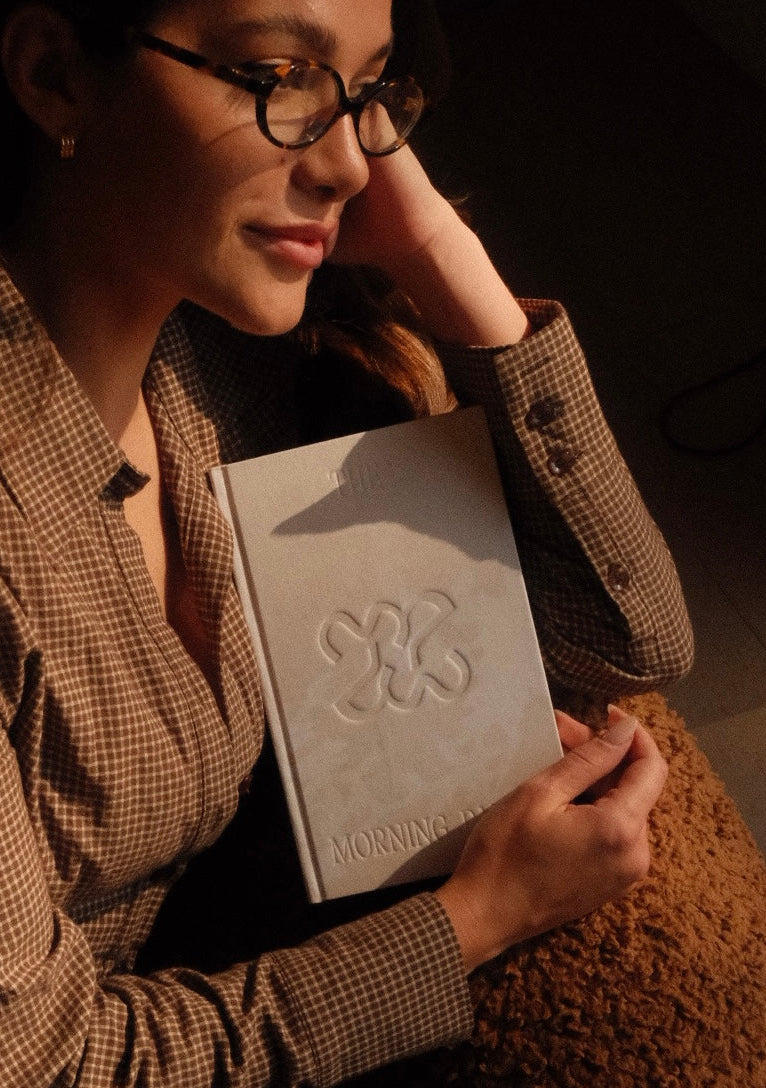 Neutral-toned gratitude journal styled with soft morning light for a calm daily ritual
