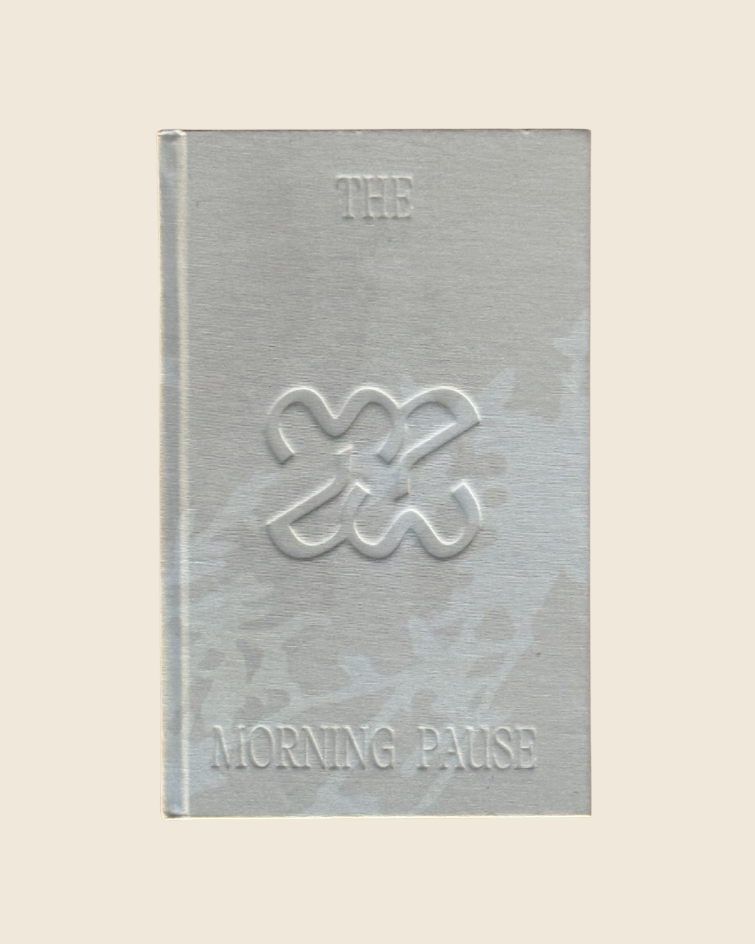 The Morning Pause gratitude journal with linen cover, embossed brand mark, and hand-painted